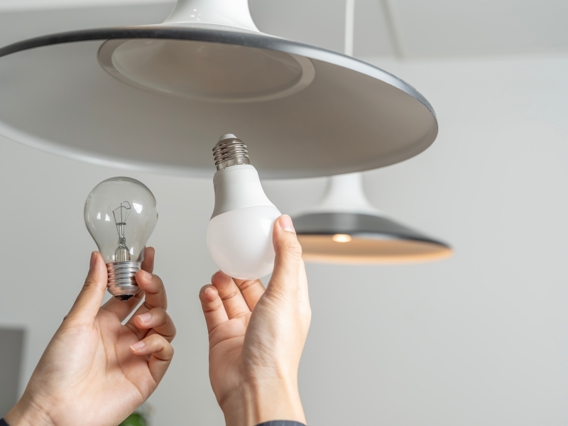 Person changing light bulb. 